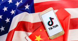 TikTok app with USA and China flags